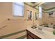 Cozy bathroom with colorful striped walls, a stylish vanity, and decorative accents at 10353 Yew Blossom Ave, Las Vegas, NV 89166
