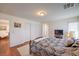 Bedroom with hardwood floors, double closet, and a view of the sitting room at 10353 Yew Blossom Ave, Las Vegas, NV 89166