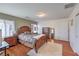 Bedroom with wood floors features a large bed, dresser, and views of a window at 10353 Yew Blossom Ave, Las Vegas, NV 89166