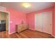 Well-lit bedroom featuring hardwood flooring, closet and neutral walls at 10353 Yew Blossom Ave, Las Vegas, NV 89166