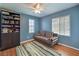Cozy bedroom featuring a ceiling fan, two windows, and modern wood flooring at 10353 Yew Blossom Ave, Las Vegas, NV 89166