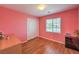 Inviting bedroom featuring wood floors, natural light, and closet space at 10353 Yew Blossom Ave, Las Vegas, NV 89166