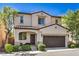 Charming two-story home with a tile roof, inviting entrance, and attached garage at 10353 Yew Blossom Ave, Las Vegas, NV 89166