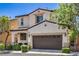 Charming two-story home with a well-manicured lawn and a two-car garage at 10353 Yew Blossom Ave, Las Vegas, NV 89166