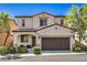 Charming two-story home with a well-manicured lawn and a two-car garage at 10353 Yew Blossom Ave, Las Vegas, NV 89166