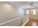 Upstairs hallway offers pristine walls, wood flooring and natural light at 10353 Yew Blossom Ave, Las Vegas, NV 89166