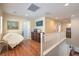 Hallway with hardwood floors and white railing overlooking lower floor at 10353 Yew Blossom Ave, Las Vegas, NV 89166