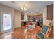 Well-lit kitchen with wood floors, island with seating, granite countertops, and stainless steel appliances at 10353 Yew Blossom Ave, Las Vegas, NV 89166