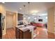 Open kitchen features island with seating, and adjoins the living room and staircase at 10353 Yew Blossom Ave, Las Vegas, NV 89166