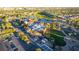 Gorgeous aerial view of a large community building surrounded by lush landscaping, mature trees, a golf course and parking at 10361 Profeta Ct, Las Vegas, NV 89135