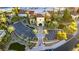 Aerial view showcases the meticulously maintained landscaping, palm trees, and ample parking surrounding the building's entrance at 10361 Profeta Ct, Las Vegas, NV 89135