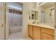 Bright bathroom boasts a tub/shower and a vanity with a mirror at 10361 Profeta Ct, Las Vegas, NV 89135