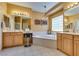 Bright bathroom with double vanities, soaking tub and glass block window at 10361 Profeta Ct, Las Vegas, NV 89135