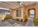Charming courtyard featuring brickwork, pergola, and desert landscaping at 10361 Profeta Ct, Las Vegas, NV 89135