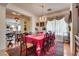 Formal dining room featuring a large table, elegant decor, and natural light at 10361 Profeta Ct, Las Vegas, NV 89135