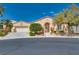 Charming single-story home featuring desert landscaping and a stylish wrought iron front door, plus an attached two-car garage at 10361 Profeta Ct, Las Vegas, NV 89135