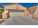 Spacious two car garage with ample parking space and desert landscaping at 10361 Profeta Ct, Las Vegas, NV 89135