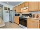 Kitchen featuring stainless steel appliances, light countertops and wood cabinets at 10361 Profeta Ct, Las Vegas, NV 89135