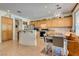 Bright kitchen featuring light wood cabinets, an island counter and dining area with backyard views at 10361 Profeta Ct, Las Vegas, NV 89135