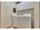 Convenient laundry room with white cabinets and modern washer and dryer at 10361 Profeta Ct, Las Vegas, NV 89135