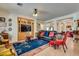 Spacious living room with custom built-ins, tile flooring, and ample seating at 10361 Profeta Ct, Las Vegas, NV 89135