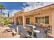 Inviting covered patio with an outdoor grill and well-maintained landscaping at 10361 Profeta Ct, Las Vegas, NV 89135