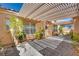 Outdoor patio with beautiful brickwork, pergola, and ample space for seating and relaxation at 10361 Profeta Ct, Las Vegas, NV 89135