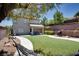 A spacious backyard with artificial turf, a patio, and a hammock, creating an ideal space for relaxation and outdoor activities at 10554 Lilac Tree Ave, Las Vegas, NV 89135