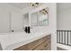 Bright bathroom featuring white counters and a wood vanity with double sinks at 10554 Lilac Tree Ave, Las Vegas, NV 89135