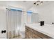 Updated bathroom with a shower-tub combination and a wood vanity at 10554 Lilac Tree Ave, Las Vegas, NV 89135