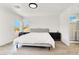 Bright bedroom with two large windows and an attached bathroom at 10554 Lilac Tree Ave, Las Vegas, NV 89135