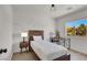 Cozy bedroom with wood furniture, a large window, and decorative lighting at 10554 Lilac Tree Ave, Las Vegas, NV 89135
