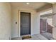 Image showcases the front door with a 'hello, goodbye' door mat, accompanied by neutral exterior finishes at 10554 Lilac Tree Ave, Las Vegas, NV 89135