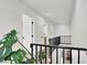 Bright hallway with black railing, neutral walls and trim, and houseplant at 10554 Lilac Tree Ave, Las Vegas, NV 89135
