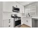 Bright kitchen with white cabinets, stainless steel appliances and herringbone tile backsplash at 10554 Lilac Tree Ave, Las Vegas, NV 89135