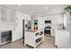 Modern kitchen featuring stainless steel appliances, a center island, and ample cabinet space at 10554 Lilac Tree Ave, Las Vegas, NV 89135