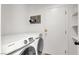 Bright laundry room features Samsung washer/dryer, storage shelves, and charming decor at 10554 Lilac Tree Ave, Las Vegas, NV 89135