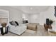 Inviting living room with a comfortable sectional sofa and hardwood floors at 10554 Lilac Tree Ave, Las Vegas, NV 89135
