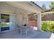 A covered patio with modern outdoor seating, perfect for relaxation and entertainment in a private outdoor setting at 10554 Lilac Tree Ave, Las Vegas, NV 89135