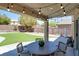 Inviting covered patio with stylish string lights, creating a cozy ambiance for outdoor gatherings and relaxation at 10554 Lilac Tree Ave, Las Vegas, NV 89135