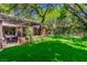 Picturesque backyard view featuring a lush lawn and a covered patio ideal for entertaining and enjoying the outdoors at 108 Quail Run Rd, Henderson, NV 89014