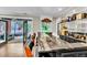 Entertaining bar with granite countertops, and stools, looking out to outdoor brick patio at 108 Quail Run Rd, Henderson, NV 89014