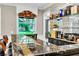 Stylish bar area featuring a granite countertop, mirrored shelves, and comfortable seating at 108 Quail Run Rd, Henderson, NV 89014
