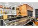 Entertaining bar with granite countertops, brick fireplace, glass shelves and black cabinets at 108 Quail Run Rd, Henderson, NV 89014