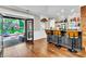 Indoor/outdoor bar area with a view of the backyard and a fully stocked bar at 108 Quail Run Rd, Henderson, NV 89014