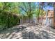 Outdoor basketball court with mature trees and an enclosing ivy wall, providing a secluded recreational space at 108 Quail Run Rd, Henderson, NV 89014