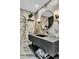 Modern bathroom with marble walls, floating vanity, and stylish fixtures at 108 Quail Run Rd, Henderson, NV 89014