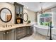 Elegant bathroom featuring a soaking tub, custom cabinetry, and a chandelier at 108 Quail Run Rd, Henderson, NV 89014