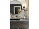 Modern bathroom with stone countertops and round mirror at 108 Quail Run Rd, Henderson, NV 89014