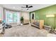 Bright Bedroom with green accent wall, wood crib, dresser, and large window at 108 Quail Run Rd, Henderson, NV 89014